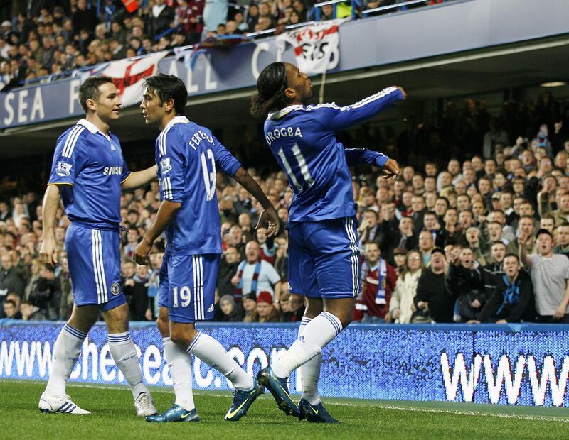 Chelsea's Ivory Coast striker Didier Drogba (R) throws a coin back at the Burnley fans during their Carling Cup 4th round match at Stamford Bridge, London, on November 12, 2008. AFP PHOTO / Glyn Kirk

FOR EDITORIAL USE ONLY Additional licence required for any commercial/promotional use or use on TV or internet (except identical online version of newspaper) of Premier League/Football League photos. Tel DataCo +44 207 2981656. Do not alter/modify photo. (Photo by GLYN KIRK / AFP)