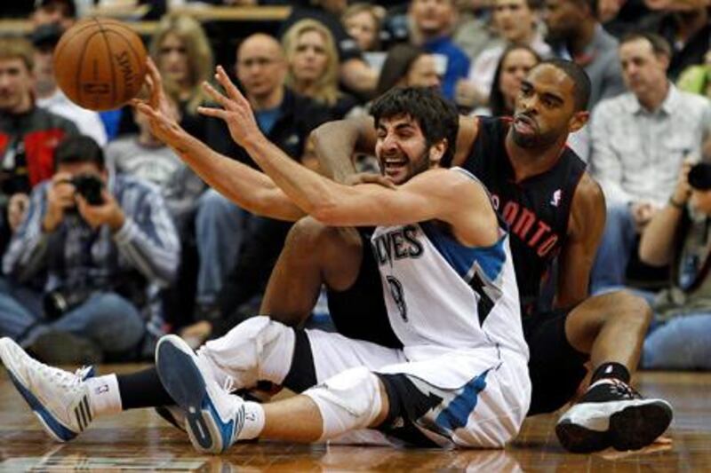 Minnesota Timberwolves guard Ricky Rubio (9) passes the ball in front of Toronto Raptors guard Alan Anderson (R) during the first half of their NBA basketball game in the Target Center in Minneapolis, April 5, 2013. REUTERS/Eric Miller (UNITED STATES - Tags: SPORT BASKETBALL)