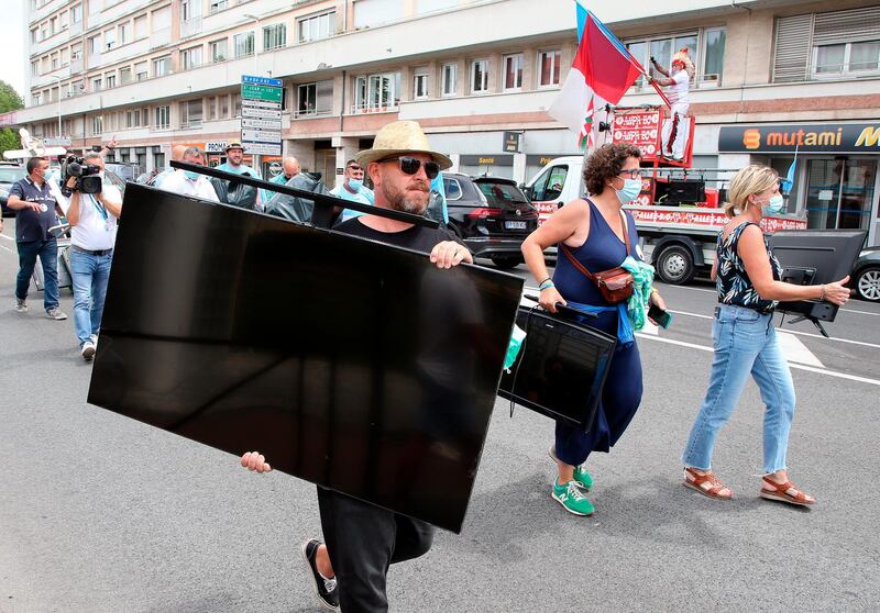 Bar owners protest after the prefect of the Pyrenees Atlantique, in France, banned bars in two cities from broadcasting on their televisions the retransmission of a local rugby match to avoid crowds. AP