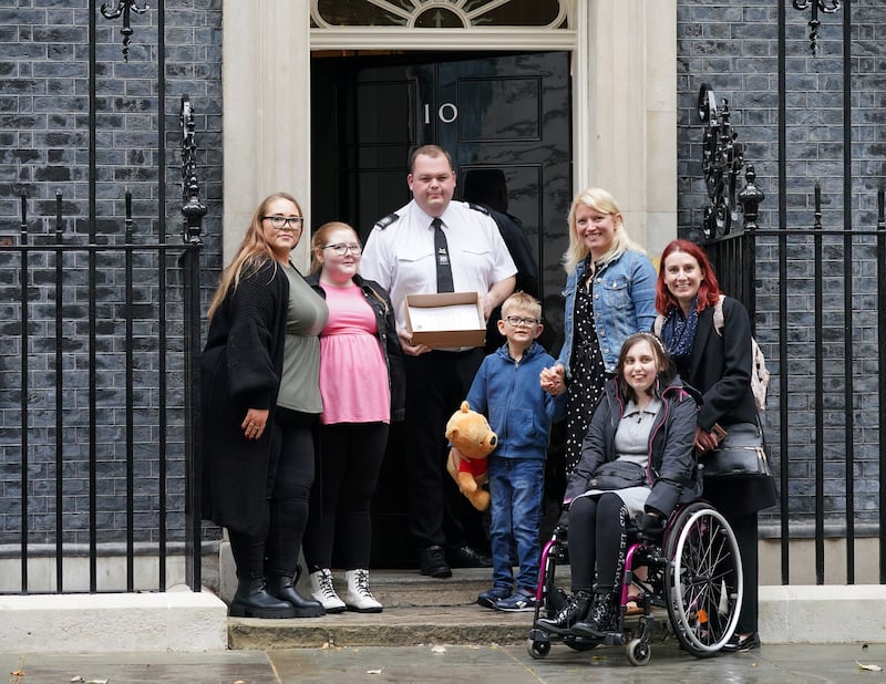 Disabled children and their families from The Let Us Learn Too campaign group hand in letters for Prime Minister Boris Johnson at 10 Downing Street, London, to raise their concerns about support for disabled children and young people, on October 15, 2021. PA Wire