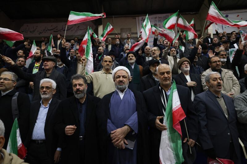 Hamid Rasaee, centre, an Iranian Shiite Muslim cleric and former member of the Islamic Consultative Assembly, attends an electoral campaign rally at a sports stadium, in Tehran. AFP