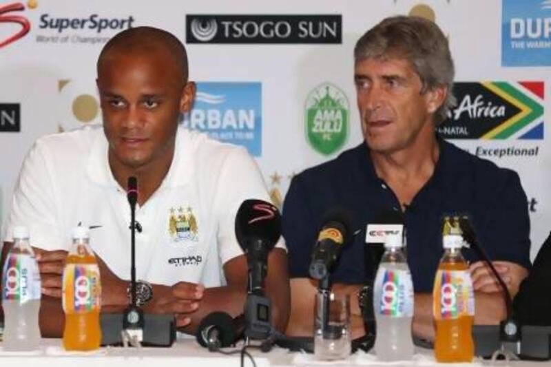 Manchester City manager Manuel Pellegrini, right, and Vincent Kompany in South Africa. Steve Haag / Getty Images