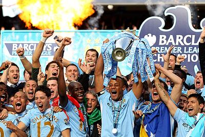 MANCHESTER, ENGLAND - MAY 13:  Vincent Kompany the captain of Manchester City lifts the trophy following the Barclays Premier League match between Manchester City and Queens Park Rangers at the Etihad Stadium on May 13, 2012 in Manchester, England.  (Photo by Alex Livesey/Getty Images)