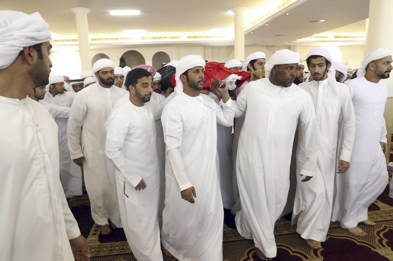 Men carry the body of First Lieutenant Pilot Jassem Saleh Al Zaabi, who died in a helicopter crash in Yemen on Friday. Al Zaabi was laid to rest in his hometown of Ras Al Khaimah on Saturday. Wam