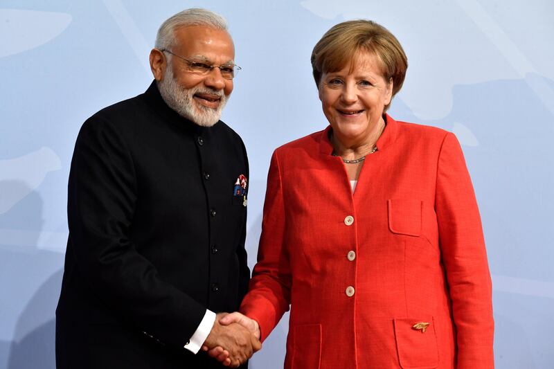 Mrs Merkel with India's premier Nardendra Modi. John MacDougall / AFP Photo