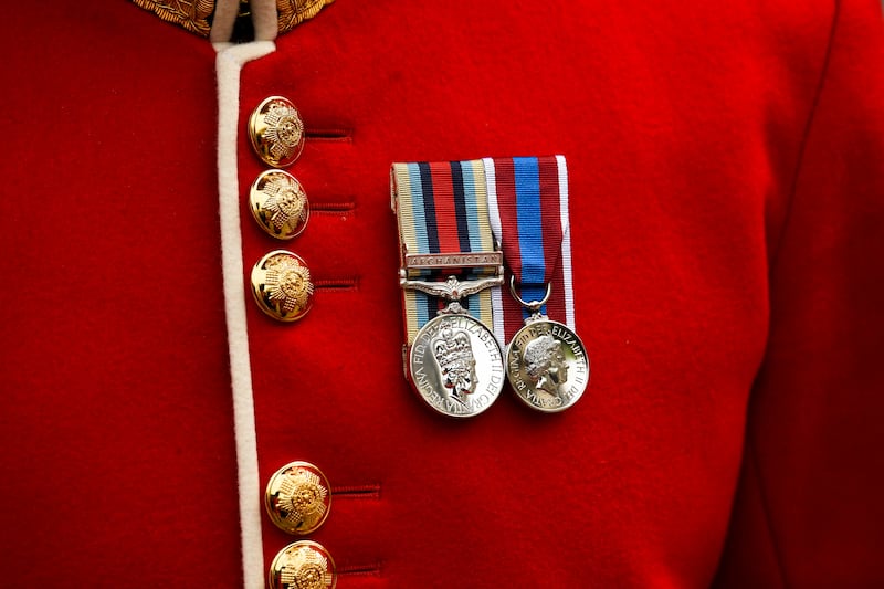 A member of the Household Division wears medals bearing the face of Britain's Queen Elizabeth, outside St Paul's Cathedral. Reuters