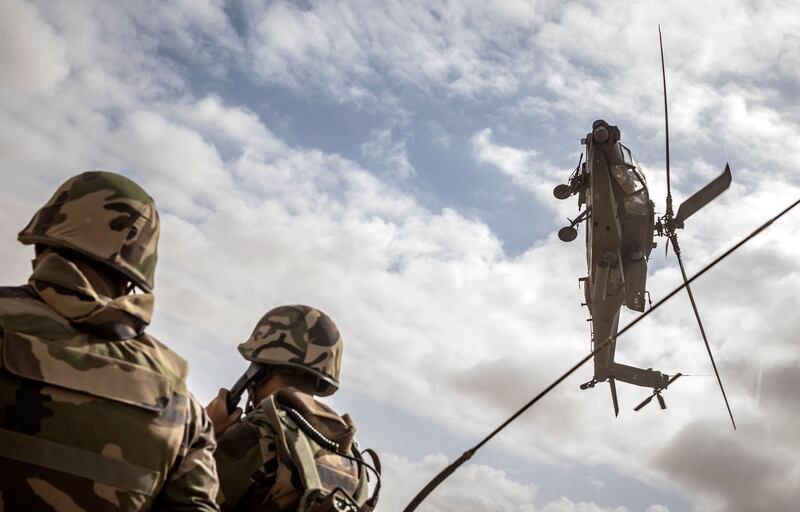 A US Apache attack helicopter flies over members of the Royal Moroccan Armed Forces during the second annual African Lion military exercise in the Tan-Tan region in south-western Morocco on June 30. AFP