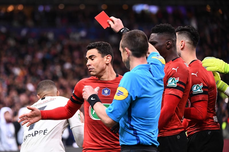 Referee Rudy Buquet is unmoved as he Kylian Mbappe gives a red card. Martin Bureau / AFP