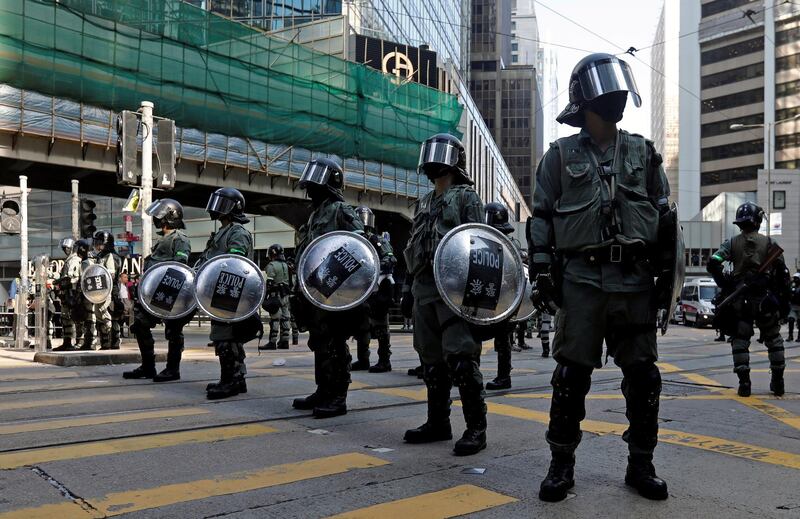 Riot police stand in the middle of a street in Central district in Hong Kong, China. Reuters