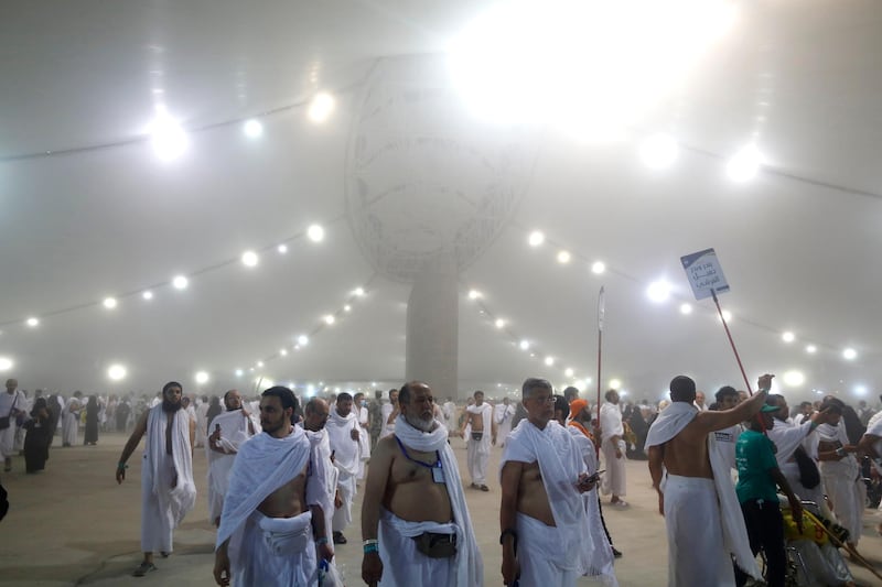 Muslim pilgrim walk after they cast stones in the last rite of the annual Hajj, on the first day of Eid al-Adha, in Mina near the holy city of Makkah, Saudi Arabia.  AP