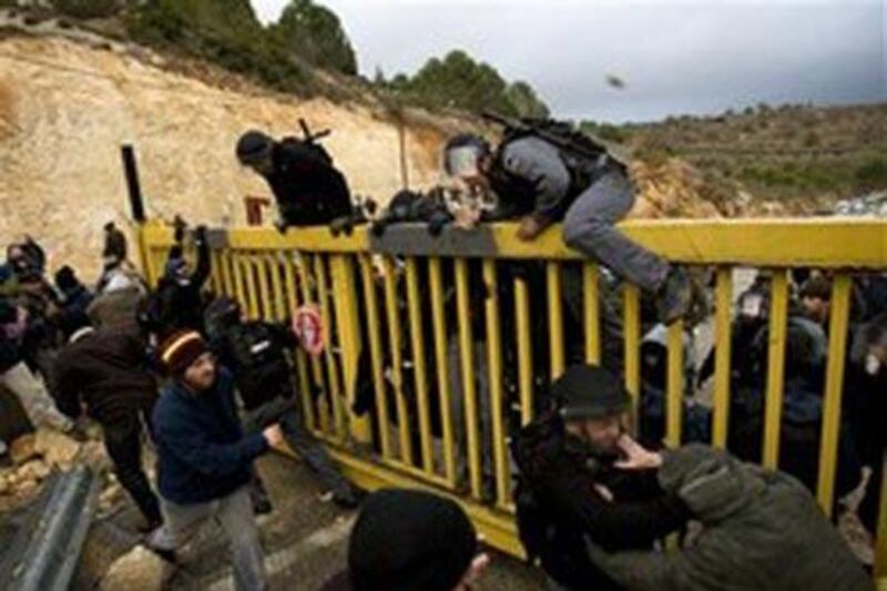 Settlers in Ma'ale Levona, the West Bank, clash with police officers and civil administration officials delivering warrants to freeze construction.