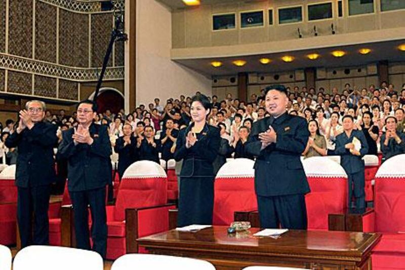 South Korean media are speculating who is the woman standing to the left of Kim Jong-un, the new North Korean leader.