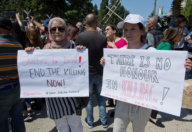 Two Palestinian women hold placards during a rally in front of the Prime Minister's office, in the West Bank city of Ramallah, Monday, Sept. 2. 2019. Hundreds of Palestinian women protested in front of the prime minister's office to demand an investigation into the death of Israa Ghrayeb, a 21-year-old woman whom many suspect was the victim of a so-called honor killing. (AP Photo/Nasser Nasser)