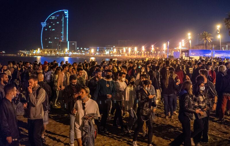 People crowd the beach in Barcelona, Spain. Barcelona residents were euphoric as the clock stroke midnight, ending a six-month-long national state of emergency and consequently, the local curfew. AP Photo