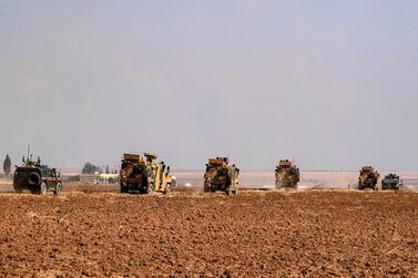 Turkish and Russian military vehicles drive on a joint patrol in the countryside of Darbasiyah town in Syria's northeastern Hasakeh province on the Syrian-Turkish border on November 1, 2019. AFP