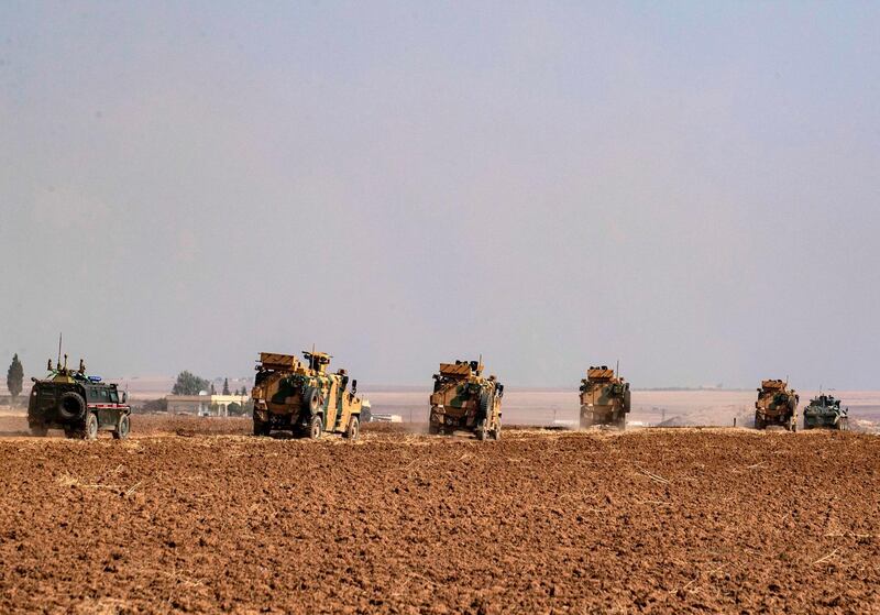 TOPSHOT - Turkish and Russian military vehicles drive on a joint patrol in the countryside of Darbasiyah town in Syria's northeastern Hasakeh province on the Syrian-Turkish border on November 1, 2019.  Turkey started joint patrols with Russia in northern Syria today to verify whether Kurdish forces have withdrawn from a key border zone in compliance with a deal reached between the two governments. The patrols follow an agreement they signed in the Black Sea resort of Sochi last week which gave Kurdish forces 150 hours to withdraw from a band of territory along the border, in a process that Russia said was now complete. / AFP / Delil SOULEIMAN
