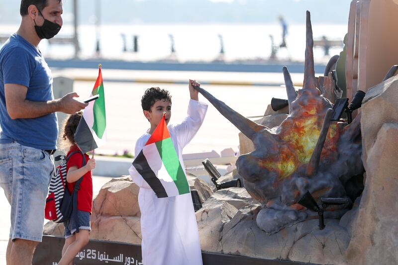 A young boy stands with pride for the UAE’s 50th National Day at the Corniche in Abu Dhabi.  Khushnum Bhandari / The National