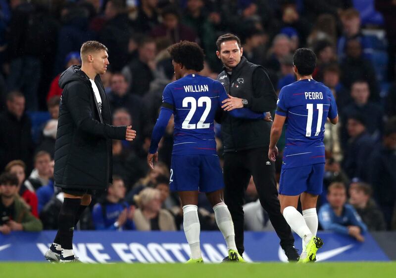 Frank Lampard embraces Chelsea players Willian and Pedro after the game. Getty Images