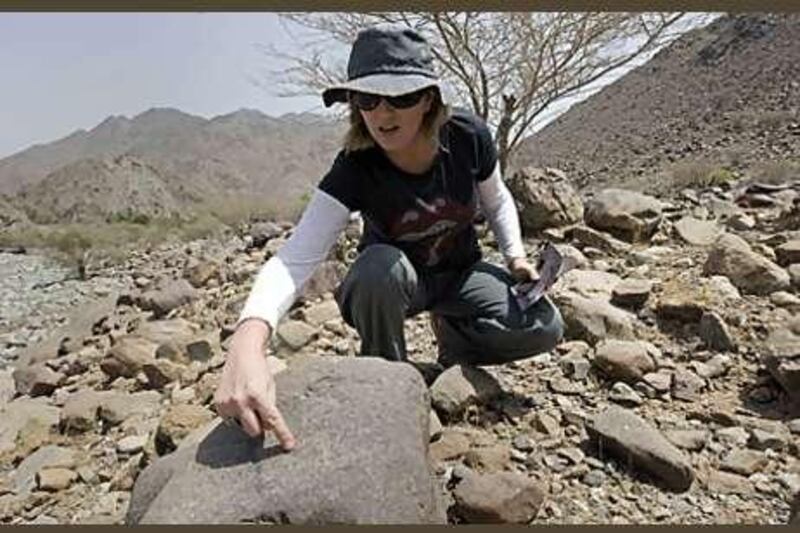 Dr Michele Ziolkowski points to one of the many petroglyphs she has discovered in Wadi Al Hayl in Fujairah. Right, petroglyphs from the Iron Age, between 1300 and 300BC.