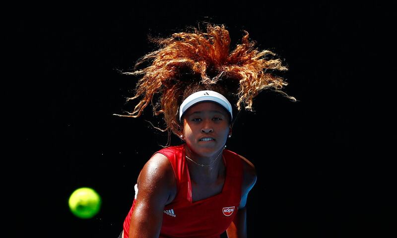 Japan's Naomi Osaka watches the ball as she serves during a practice session ahead of the 2018 Australian Open in Melbourne.  Scott Barbour / Getty Images