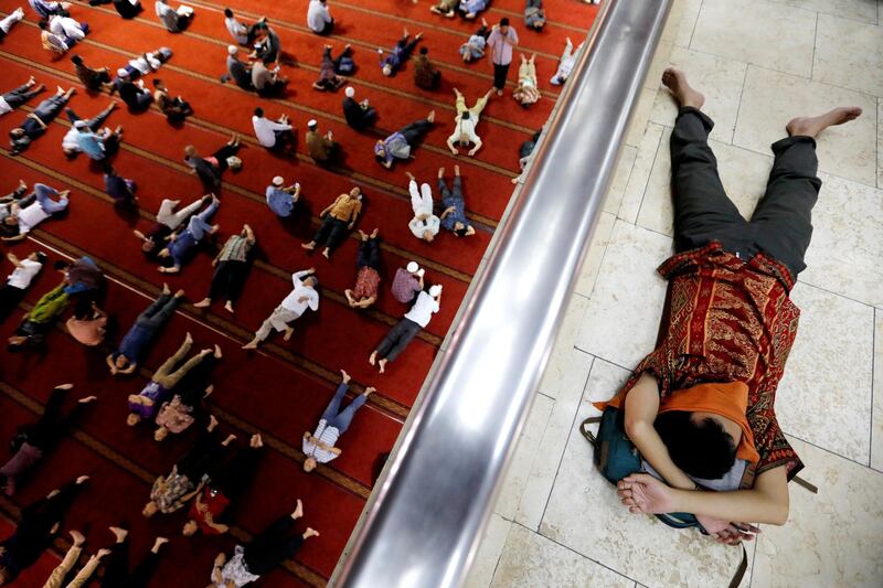 Muslim men take a rest after attending Friday prayers in Jakarta. Reuters