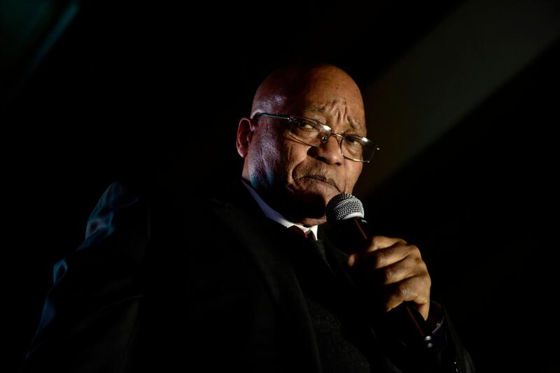 South African President Jacob Zuma gestures as he addresses supporters outside the South African Parliament in Cape Town on August 8, 2017, after surviving a Motion of No confidence. 
South African President Jacob Zuma has survived a parliamentary vote of no confidence, with enough ANC lawmakers sticking by their leader despite divisions and fierce criticism of his rule. The motion brought by the opposition needed to secure 201 of the 400 votes in parliament to succeed, but fell short with 177 votes, national assembly Speaker Baleka Mbete announced.
 / AFP PHOTO / PIETER BAUERMEISTER