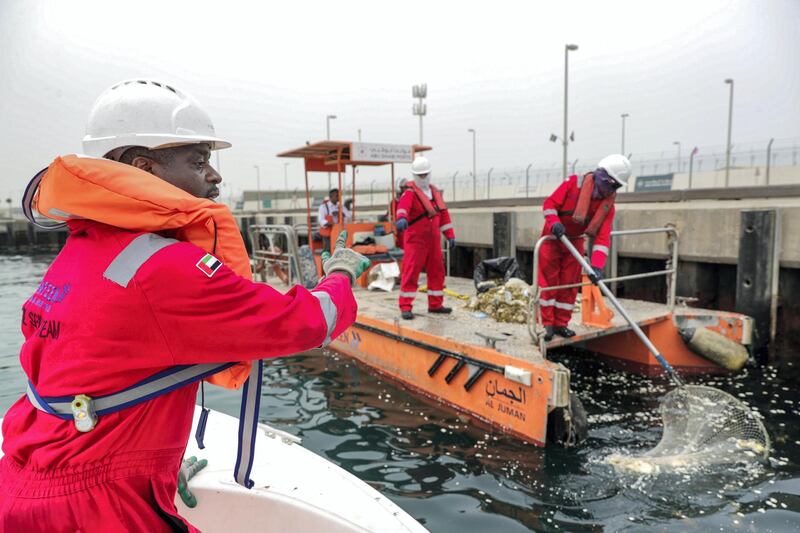Abu Dhabi, United Arab Emirates, April 2, 2019.  Aubu Dhabi Ports trip on a ship that collects tons of floating sea debris. --  Team Captain, Saleh Mohammed coordinates with his clean up crew.
Victor Besa/The National
Section:  NA
Reporter:  John Dennehy