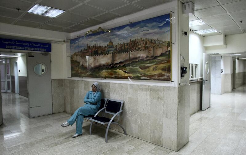 TO GO WITH AFP STORY BY MAJEDA EL-BATSH
A Palestinian nurse sits outside the obstetrics and gynecology ward at the Makassed Hospital in Jerusalem on August 1, 2012. The hospital, which is threatened with closure due to a financial crisis, is facing an open-ended strike by its staff members who haven't been receiving wages for the past two months. AFP PHOTO/HAZEM BADER (Photo by HAZEM BADER / AFP)