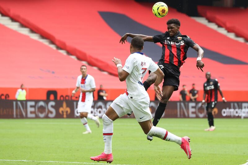 Nice's French defender Andy Pelmard, right, heads the ball. AFP