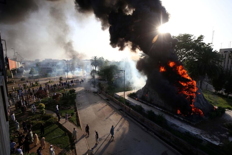 The Radio Pakistan premises after it was set on fire during clashes between police and Khan supporters in Peshawar. EPA