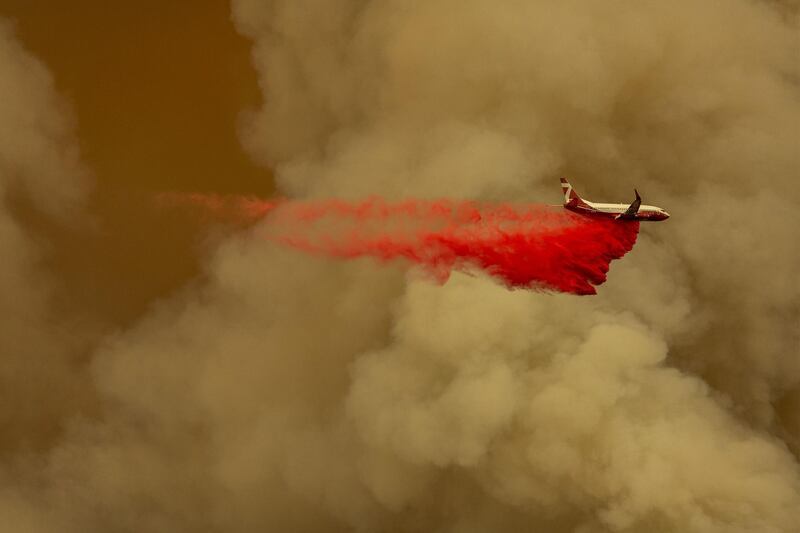 A Coulson 737 firefighting tanker jet drops fire retardant to slow Bobcat Fire at the top of a major run up a mountainside in the Angeles National Forest. AFP