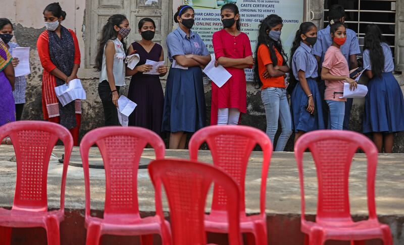 Pupils queue for a Covid-19 vaccine shot at Chogle High School in Borivali, Mumbai. India recorded 7,743 Omicron variant cases in the past 24 hours. EPA
