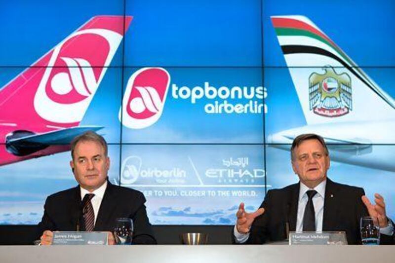 James Hogan, the president and chief executive of Etihad Airways, left, with Hartmut Mehdorn, the head of the Air Berlin board, at a press conference in Berlin on December 18. Michael Kappler / AFP