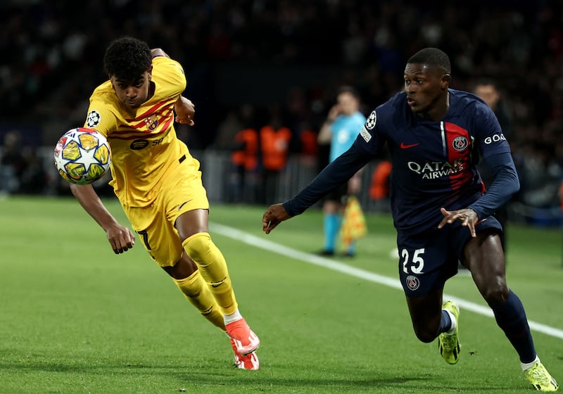 Barcelona forward Lamine Yamal, left, up against and Paris Saint-Germain defender Nuno Mendes. AFP
