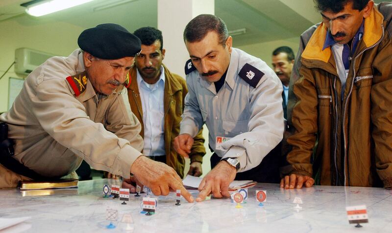 Iraqi military officers discuss security operations over a 'wargaming' table at Iraq's Permanent Joint Operations Centre in Basra. AFP