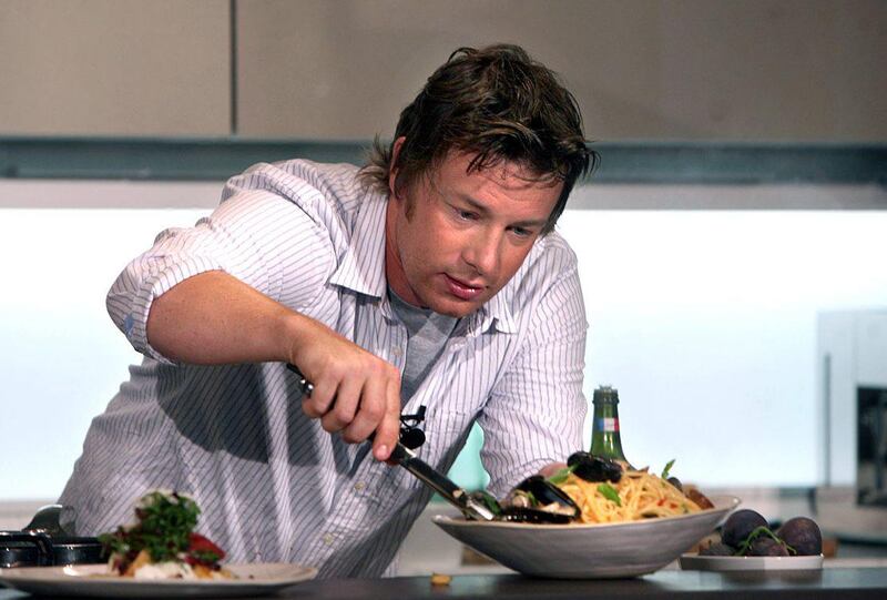 DUBAI, UNITED ARAB EMIRATES - OCTOBER 12:  Jamie Oliver, the British celebrity chef, during a cooking demonstration to launch his partership with Leisurecorp who are developing the Jumeirah Golf Estate, in Dubai on October 12, 2008.  Oliver will be designing kitchens for the new project and launching two new restaurants in Dubai, also at the Jumeriah Golf Estate, one Italian and one BBQ- themed restaurant. The event was held at The One & Only Royal Mirage hotel in Dubai.  (Randi Sokoloff / The National)  To go with story by Melanie Swan. *** Local Caption ***  RS008-1012-Oliver.jpgRS008-1012-Oliver.jpgBZ26AU SB OLIVER.jpg