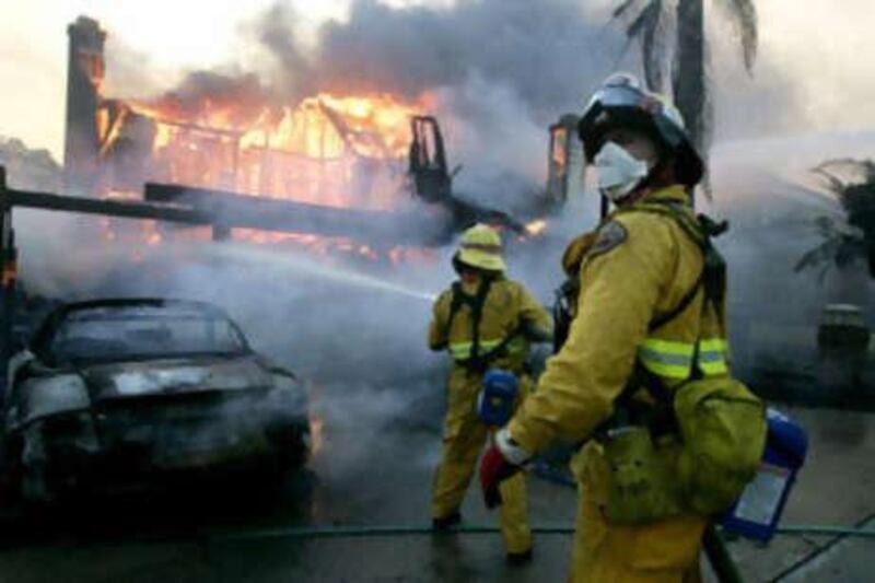 Firefighters battle a blaze on Nov 15 2008 in Yorba Linda, California. Strong Santa Ana winds are fanning flames throughout Southern California, destroying hundreds of homes and causing thousands to evacuate.
