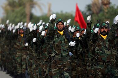 Members of the paramilitary Popular Mobilisation Forces take part in their graduation ceremony at a military camp in Karbala last month. Reuters