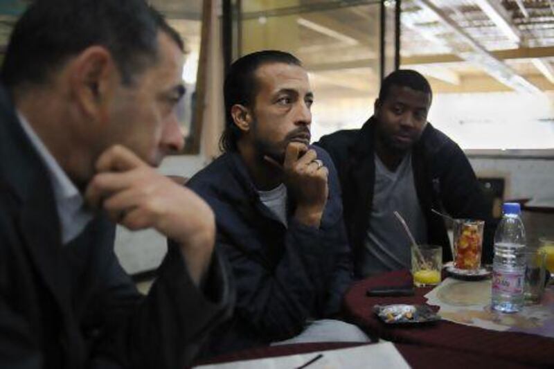 Taher Belabbes, a protest leader from the city of Ouargla, with friends at a coffee shop in the bus station of Algiers.