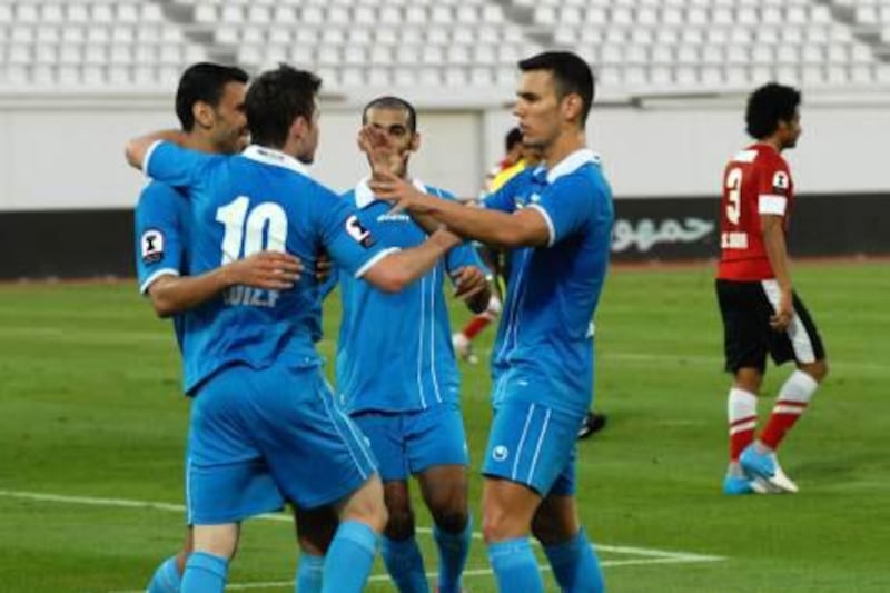 Dibba players celebrate their win against Al Ahli.