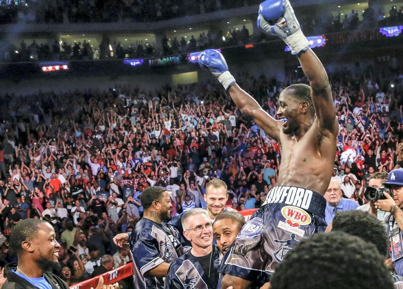 Terence "Bud" Crawford celebrates his win by knockout against Julius Indongo in the third round of a junior welterweight world title unification bout in Lincoln, Neb., Saturday, Aug. 19, 2017. Undefeated Crawford now holds the WBO, WBC, IBF and WBA 140 pound world titles. It was only the second fight in the four-belt era in which all four titles were on the line. (AP Photo/Nati Harnik)