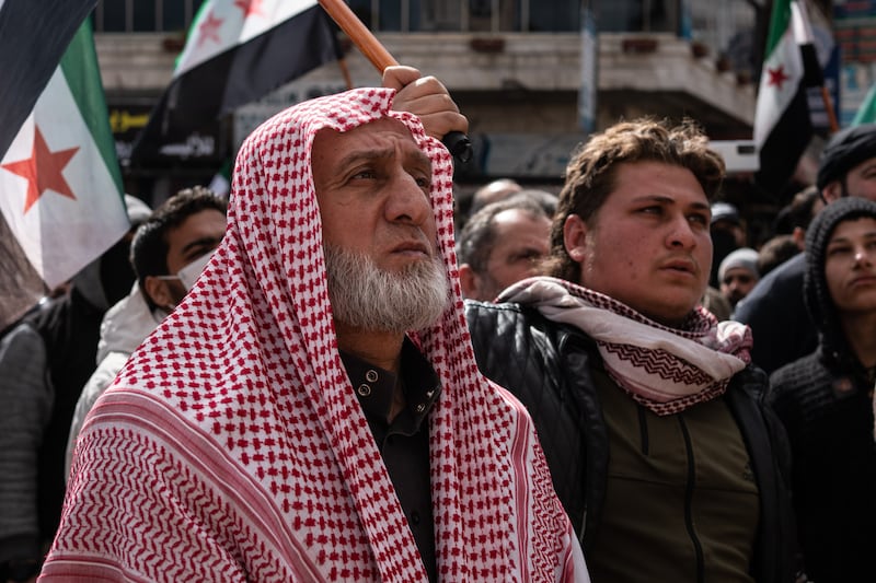 Ahmed Al Ali, left, said 'today, we came to the squares to renew our pledge once again and to affirm the overthrow of the Syrian regime and that the oppressors cannot rule us'