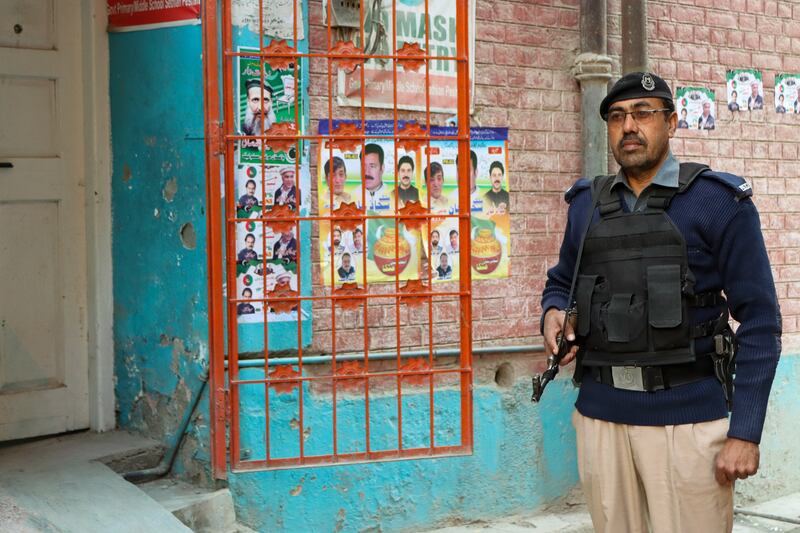 A security guard on duty outside the polling station in Peshawar. Musa Kamal for The National