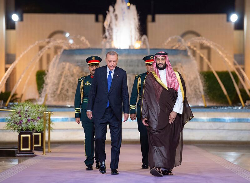 Mr Erdogan and Prince Mohammed walk to a welcome ceremony at Al Salam Palace in Jeddah, Saudi Arabia. AP