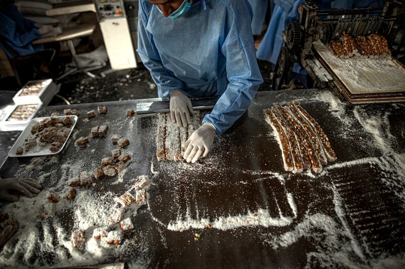 The sweets are cut into bite-sized squares and covered in sugar. 