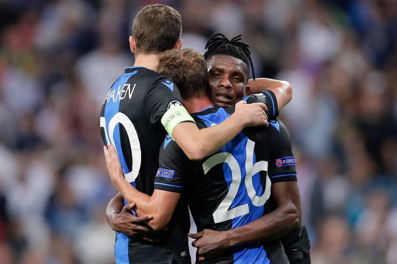 Brugge's Hans Vanaken, Mats Rits and Amadou Sagna elebrate their side 2-2 draw at the end of the Champions League group A soccer match between Real Madrid and Club Brugge, at the Santiago Bernabeu stadium in Madrid. AP Photo