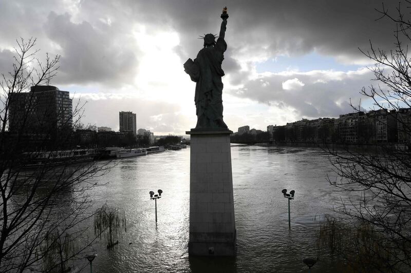 The flooded Ile aux Cygnes and banks of the river Seine with a model of the Statue of Liberty in Paris. Ludovic Marin / AFP
