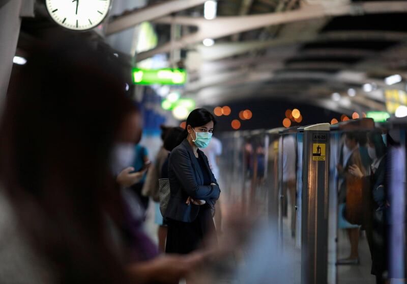 A woman wears a mask to prevent the spread of the new coronavirus as she waits for a train at Bangkok, Thailand February 2, 2020. REUTERS/Soe Zeya Tun