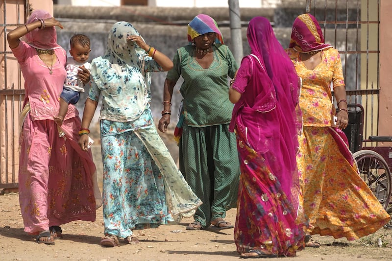 Women arrive at a polling station to cast their ballots in Parbatsar, Rajasthan. AFP