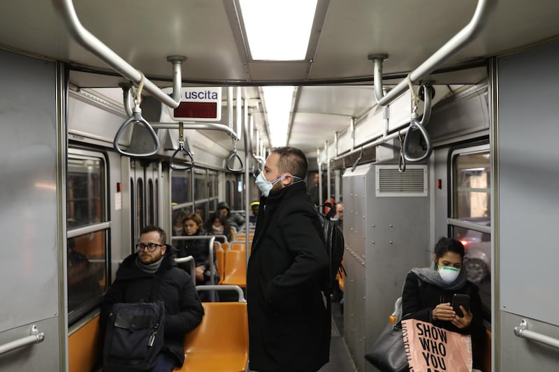 Passengers of the public transport wear a protective mask in Milan, Italy due to coronavirus outbreak.  Getty